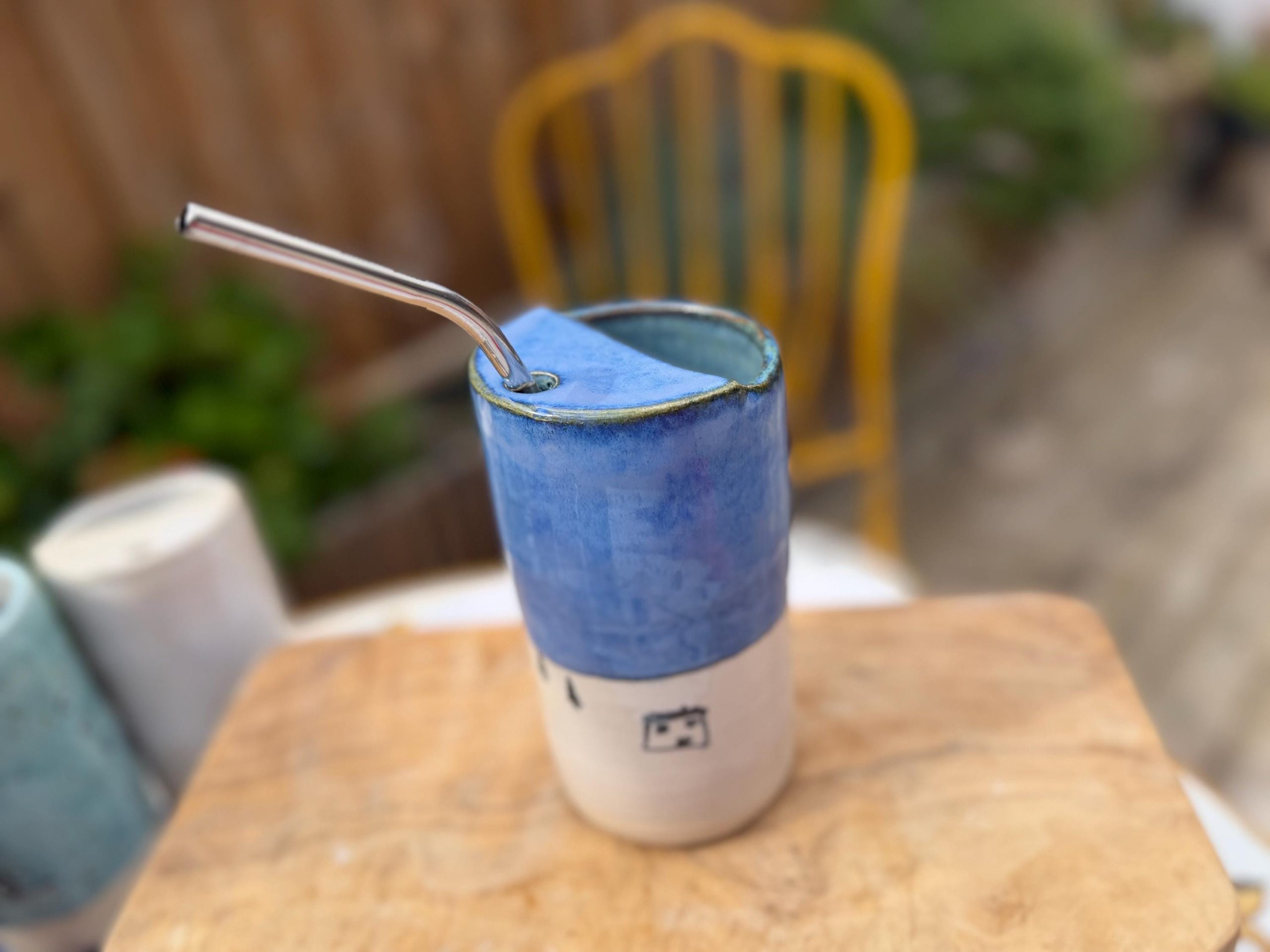 Handmade Blue Ceramic Travel Mug with House Motif & Metal Straw - Image 2